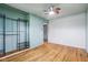 Empty bedroom includes a ceiling fan, wire shelving, and hardwood floors at 3921 S Lasalle St, Indianapolis, IN 46237