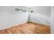 Bright bedroom featuring hardwood floors and multiple windows providing ample natural light at 3921 S Lasalle St, Indianapolis, IN 46237