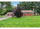 Charming brick home with a well-maintained lawn and a detached two-car garage at 3921 S Lasalle St, Indianapolis, IN 46237