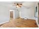 A spacious living room features hardwood floors and a ceiling fan at 3921 S Lasalle St, Indianapolis, IN 46237
