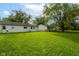 Large grassy backyard with white house in the background at 3965 Alsace Pl, Indianapolis, IN 46226
