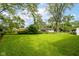 Wide grassy backyard with several structures in the background at 3965 Alsace Pl, Indianapolis, IN 46226