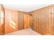 Wood-paneled bedroom with closet, window, and wall lighting at 3965 Alsace Pl, Indianapolis, IN 46226