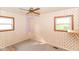 Patterned wallpaper bedroom with dual windows and a ceiling fan at 3965 Alsace Pl, Indianapolis, IN 46226