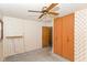 Bedroom features outdated wallpaper, closet space, and ceiling fan at 3965 Alsace Pl, Indianapolis, IN 46226