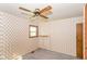 Bedroom features patterned wallpaper, a ceiling fan, and natural light at 3965 Alsace Pl, Indianapolis, IN 46226