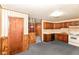 Quaint kitchen area with wood cabinets and appliances, near living space at 3965 Alsace Pl, Indianapolis, IN 46226