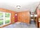 Entry and living area with paneled walls, carpet, and natural light from large window at 3965 Alsace Pl, Indianapolis, IN 46226