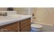 Classic bathroom features a vanity with white countertop, warm wood cabinetry, and a shower-tub combination at 403 Bagley Ln, Indianapolis, IN 46231