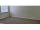 A bright bedroom with neutral walls, carpet, and a window with blinds at 403 Bagley Ln, Indianapolis, IN 46231