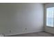 Well-lit room featuring a window with blinds and neutral carpet at 403 Bagley Ln, Indianapolis, IN 46231