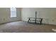 Spacious carpeted room with a large window and TV stand at 403 Bagley Ln, Indianapolis, IN 46231