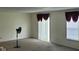 Bright living area with sliding glass doors and large windows, offering ample natural light and comfortable carpet at 403 Bagley Ln, Indianapolis, IN 46231