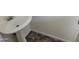 Simple pedestal sink with tiled floors in a modest bathroom with neutral colored walls at 403 Bagley Ln, Indianapolis, IN 46231