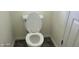 Standard white toilet with a closed lid, located in a modest bathroom with neutral-colored walls at 403 Bagley Ln, Indianapolis, IN 46231