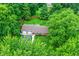Lush aerial view of this home, surrounded by dense trees, reveals a large yard and inviting outdoor spaces at 4132 Tincher Rd, Indianapolis, IN 46221