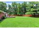 Expansive backyard with lush greenery and a cozy deck area, ideal for outdoor gatherings at 4132 Tincher Rd, Indianapolis, IN 46221
