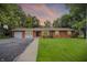 Attractive brick home with an attached garage, driveway and a well-kept lawn at 4132 Tincher Rd, Indianapolis, IN 46221