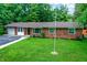 Well-maintained home with a brick exterior and a lush green lawn at 4132 Tincher Rd, Indianapolis, IN 46221