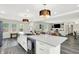 Bright, open kitchen with a marble island, stainless steel appliances, and stylish pendant lighting at 4132 Tincher Rd, Indianapolis, IN 46221