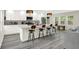 Modern kitchen with white cabinets, stylish lighting, and a large center island with barstool seating at 4132 Tincher Rd, Indianapolis, IN 46221