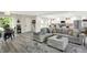 Bright and open living room with modern gray floors and furniture adjacent to kitchen at 4132 Tincher Rd, Indianapolis, IN 46221