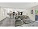A cozy living room with a gray sectional sofa and views into the modern kitchen at 4132 Tincher Rd, Indianapolis, IN 46221