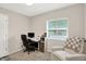 This home office is furnished with a desk, computer, and comfortable chair with natural light from the window at 4132 Tincher Rd, Indianapolis, IN 46221