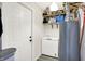 Functional utility room with ample storage, featuring a chest freezer, shelves, and a modern door at 4132 Tincher Rd, Indianapolis, IN 46221