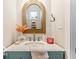 Charming powder room featuring an ornate gold mirror and modern fixtures at 48 E Palmer St, Indianapolis, IN 46225