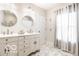 Bright bathroom features a double vanity with two sinks and herringbone tile floors at 48 E Palmer St, Indianapolis, IN 46225