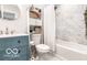 Well-lit bathroom features modern fixtures, marble-look tile, and a built-in linen cabinet at 48 E Palmer St, Indianapolis, IN 46225