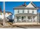 Charming two-story home with a covered front porch and a well-maintained yard at 48 E Palmer St, Indianapolis, IN 46225