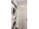 Convenient laundry room with stacked washer and dryer, and a white door at 48 E Palmer St, Indianapolis, IN 46225