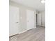 Bright bedroom with light gray walls, updated floors, and multiple doors for easy access at 508 W 38Th St, Indianapolis, IN 46208