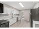 Modern kitchen with gray subway tile backsplash, white cabinets, stainless steel appliances, and updated floors at 508 W 38Th St, Indianapolis, IN 46208
