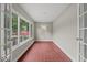 Bright sunroom with ample natural light, french doors, red tile flooring, and neutral decor at 508 W 38Th St, Indianapolis, IN 46208