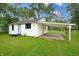 A white home featuring an attached carport in a charming residential neighborhood at 523 Patterson Rd, Columbus, IN 47203