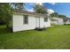 Back exterior view of home with white siding and green grass at 523 Patterson Rd, Columbus, IN 47203