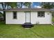Back exterior featuring white siding with black trim around the door and windows at 523 Patterson Rd, Columbus, IN 47203