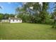 Wide shot of backyard including home and large trees at 523 Patterson Rd, Columbus, IN 47203