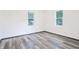 Bedroom with vinyl floor and two large windows offering plenty of natural light at 523 Patterson Rd, Columbus, IN 47203