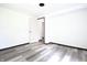 Bright bedroom featuring sleek gray wood floors, fresh white walls and modern black trim at 523 Patterson Rd, Columbus, IN 47203