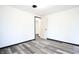 Bright bedroom featuring sleek gray wood floors, fresh white walls and modern black trim at 523 Patterson Rd, Columbus, IN 47203