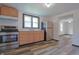 Bright kitchen has stainless steel appliances, wood cabinets and durable vinyl floors at 523 Patterson Rd, Columbus, IN 47203