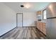 Bright kitchen has stainless steel appliances, wood cabinets and durable vinyl floors at 523 Patterson Rd, Columbus, IN 47203
