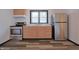 Bright kitchen has stainless steel appliances, wood cabinets and durable vinyl floors at 523 Patterson Rd, Columbus, IN 47203