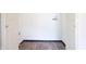 A bright and empty laundry room awaits with water connections and modern vinyl flooring at 523 Patterson Rd, Columbus, IN 47203