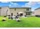 Spacious backyard featuring a well-manicured lawn, patio seating, and an outdoor basketball hoop at 5306 Lavender Dr, Plainfield, IN 46168