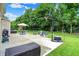 Spacious backyard with lush lawn, patio seating, basketball hoop, and charming playground at 5306 Lavender Dr, Plainfield, IN 46168